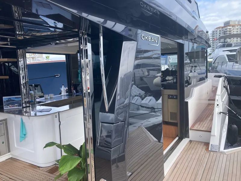 Slide: The Image of 2024 OKEAN 52 yacht with sleek design and modern interior at a marina. - 35