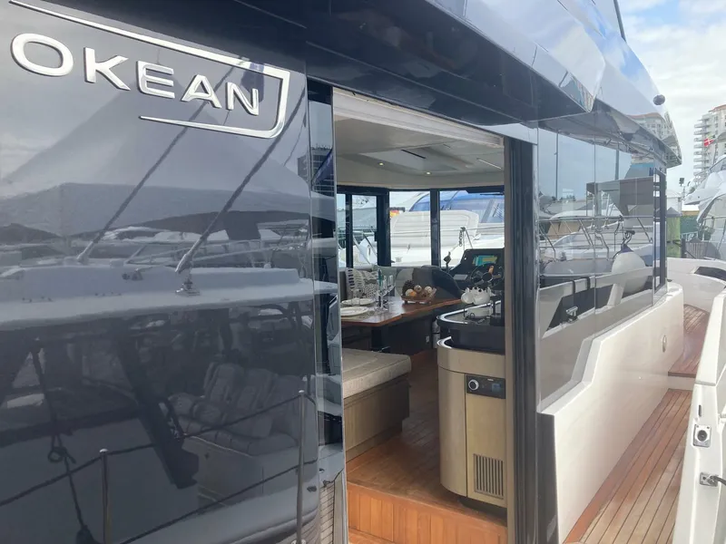 Slide: The Image of 2024 OKEAN 52 yacht with sleek design and luxurious interior at a marina. - 36