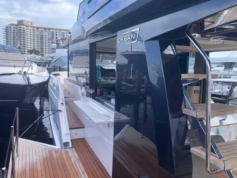 Slide: The Image of 2024 OKEAN 52 yacht with sleek design, docked at marina. - 39