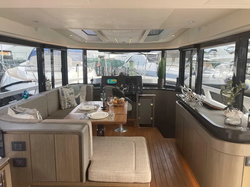 Slide: The Image of Luxurious interior of 2024 OKEAN 52 yacht with elegant dining area and panoramic windows. - 40