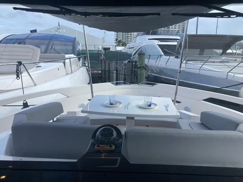 Slide: The Image of 2024 OKEAN 52 yacht with elegant outdoor dining setup at marina. - 44