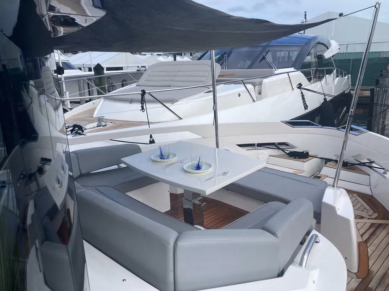 Slide: The Image of Luxurious 2024 OKEAN 52 yacht with elegant outdoor seating and dining area. - 45