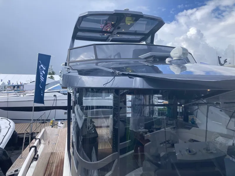 Slide: The Image of 2024 OKEAN 52 yacht docked at marina under cloudy sky. - 49