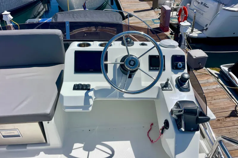 Slide: The Image of Cockpit of 2023 Beneteau Antares 11 Fly with steering wheel and controls. - 11