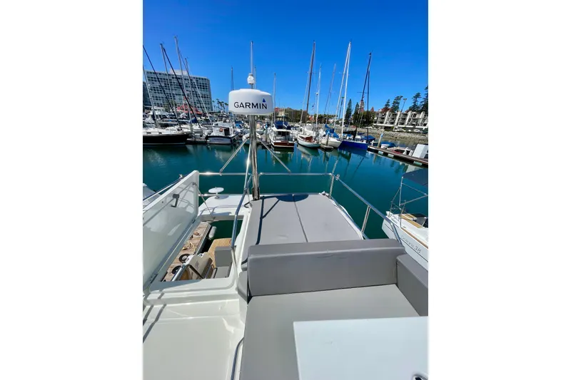 Slide: The Image of 2023 Beneteau Antares 11 Fly yacht docked in a marina with clear blue skies. - 16