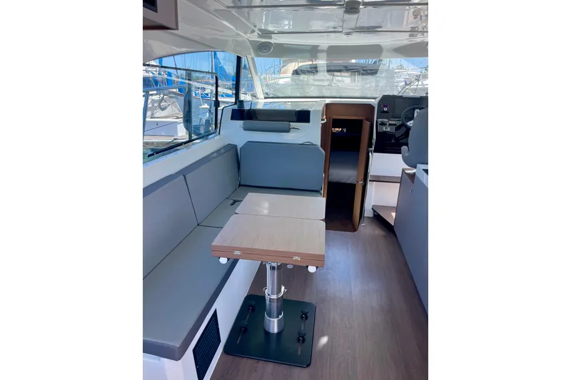 Slide: The Image of Interior of 2023 Beneteau Antares 11 Fly, featuring seating and table in cabin. - 17
