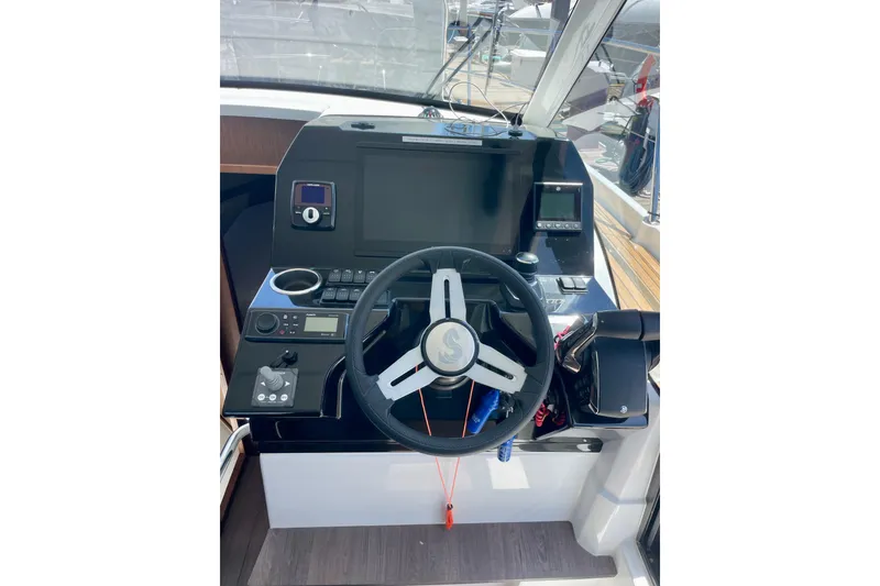 Slide: The Image of Helm station of 2023 Beneteau Antares 11 Fly with modern navigation controls. - 18