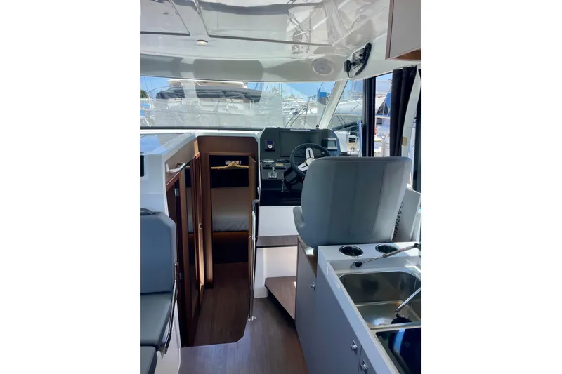 Slide: The Image of Interior view of 2023 Beneteau Antares 11 Fly, featuring helm and cabin entrance. - 19