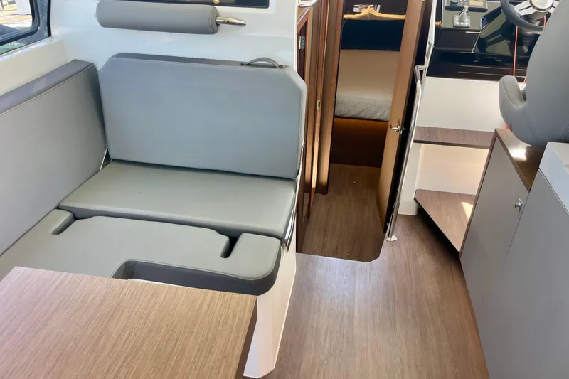 Slide: The Image of Interior of 2023 Beneteau Antares 11 Fly, featuring modern seating and wood accents. - 21