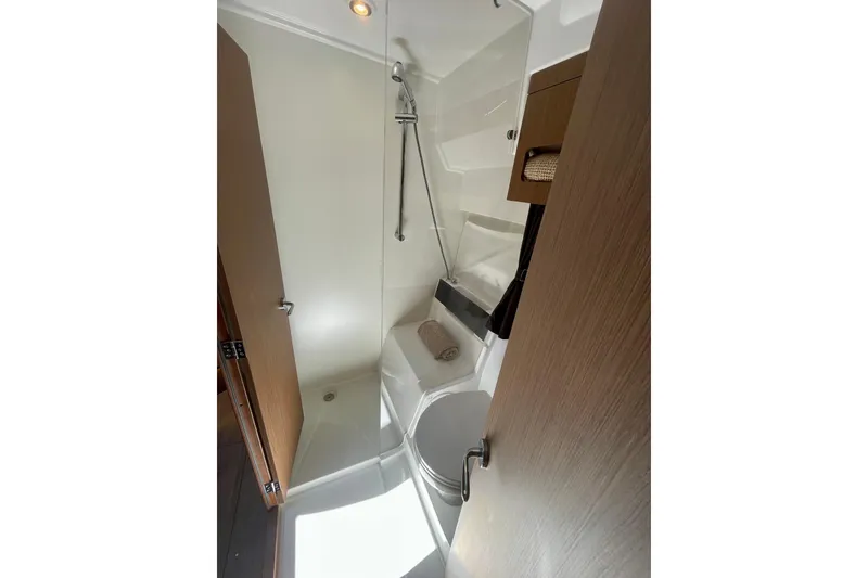 Slide: The Image of Bathroom interior of 2023 Beneteau Antares 11 Fly, featuring modern shower and wooden accents. - 25