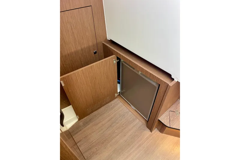 Slide: The Image of Interior view of 2023 Beneteau Antares 11 Fly, featuring wooden cabinetry and flooring. - 26