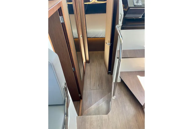 Slide: The Image of Interior view of 2023 Beneteau Antares 11 Fly, showcasing wooden flooring and cabin entrance. - 27