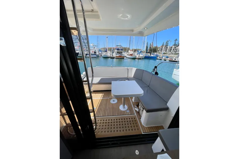 Slide: The Image of 2023 Beneteau Antares 11 Fly yacht interior with seating and table, docked at marina. - 28