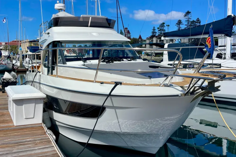 Slide: The Image of 2023 Beneteau Antares 11 Fly yacht docked at marina, showcasing sleek design and modern features. - 3