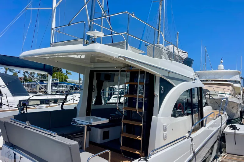 Slide: The Image of 2023 Beneteau Antares 11 Fly yacht docked, showcasing flybridge and sleek design. - 30