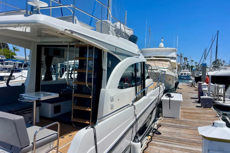 Slide: The Image of 2023 Beneteau Antares 11 Fly yacht docked at marina, showcasing sleek design and spacious deck. - 31