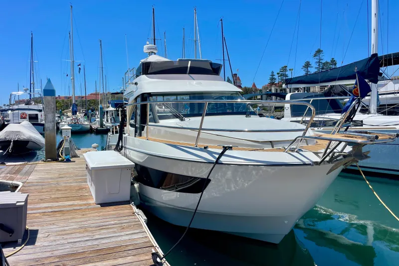 Slide: The Image of 2023 Beneteau Antares 11 Fly yacht docked at a marina under clear blue skies. - 32