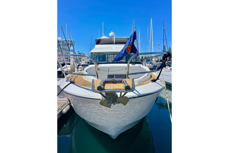 Slide: The Image of 2023 Beneteau Antares 11 Fly yacht docked in marina, front view with blue sky. - 4