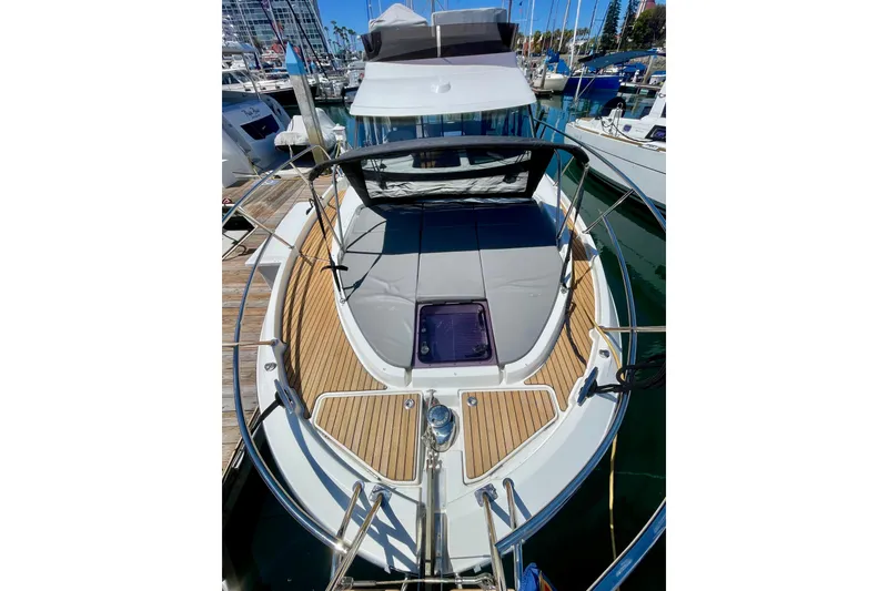 Slide: The Image of 2023 Beneteau Antares 11 Fly yacht with teak deck and sunbathing area in marina. - 6