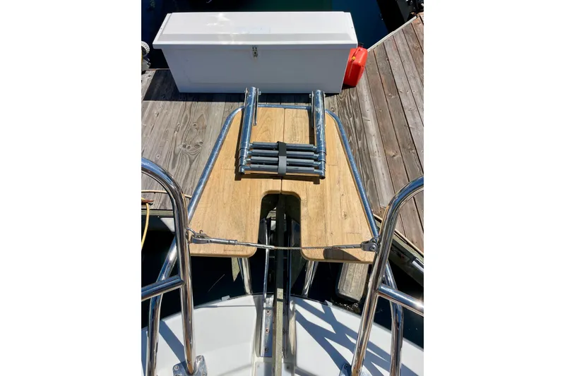 Slide: The Image of 2023 Beneteau Antares 11 Fly swim platform with ladder and dock view. - 7