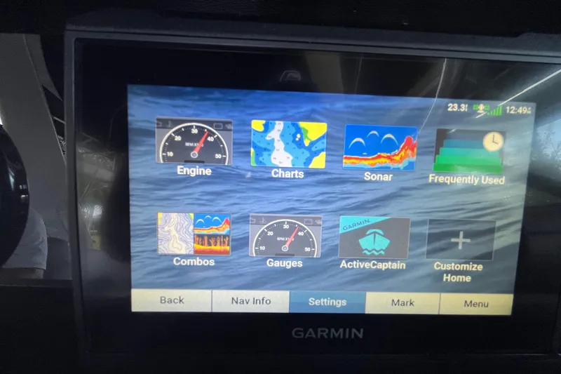 Slide: The Image of Garmin display on 2022 Crownline 260 XSS boat showing navigation and engine options. - 10