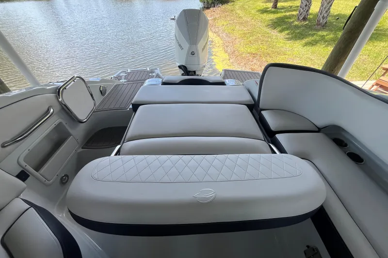 Slide: The Image of 2022 Crownline 260 XSS boat interior with luxurious seating and lake view. - 15