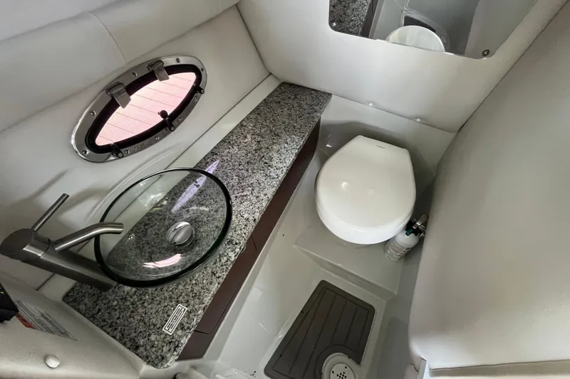 Slide: The Image of 2022 Crownline 260 XSS boat bathroom with granite countertop and modern fixtures. - 16