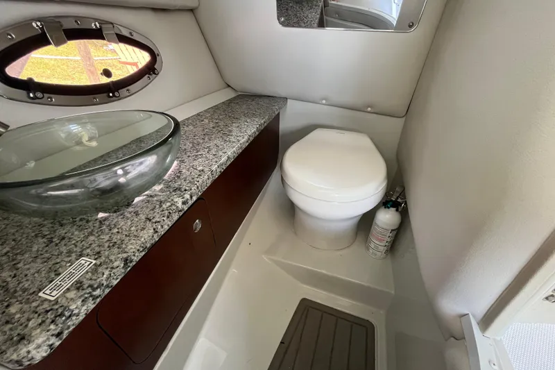Slide: The Image of 2022 Crownline 260 XSS boat bathroom with granite countertop and modern fixtures. - 17