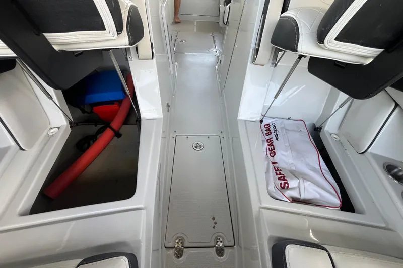 Slide: The Image of 2022 Crownline 260 XSS boat interior with safety gear bag and storage compartments. - 20