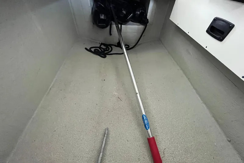 Slide: The Image of Storage compartment of 2022 Crownline 260 XSS boat with equipment and rope. - 23