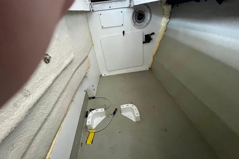 Slide: The Image of Interior of 2022 Crownline 260 XSS boat showing storage compartment and fittings. - 25