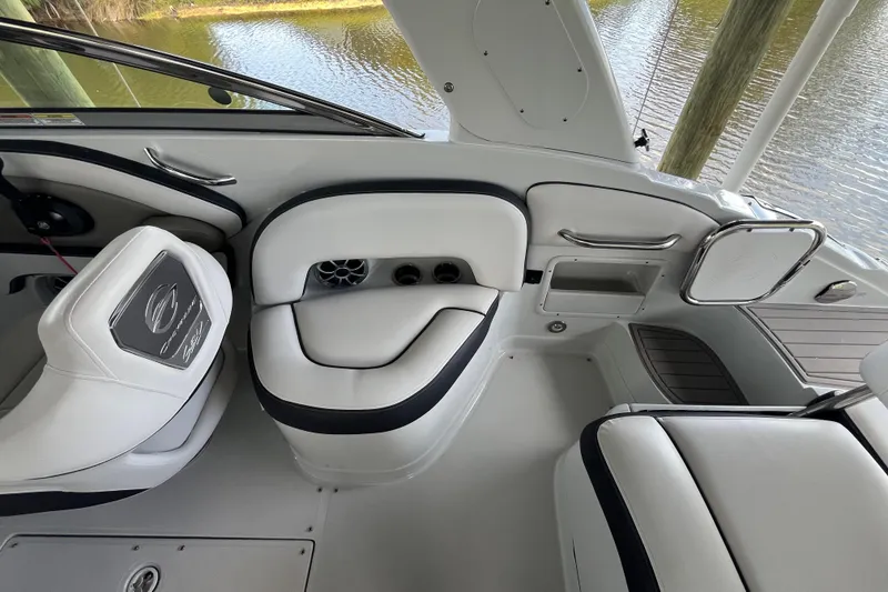 Slide: The Image of Interior of 2022 Crownline 260 XSS boat with white seating and sleek design. - 26