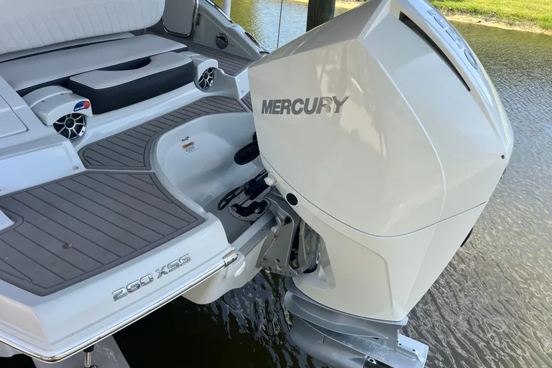 Slide: The Image of 2022 Crownline 260 XSS boat with Mercury outboard engine, docked on water. - 30