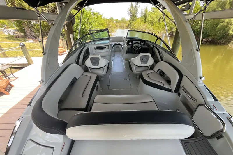 Slide: The Image of 2022 Crownline 260 XSS boat interior with sleek seating and modern dashboard. - 4