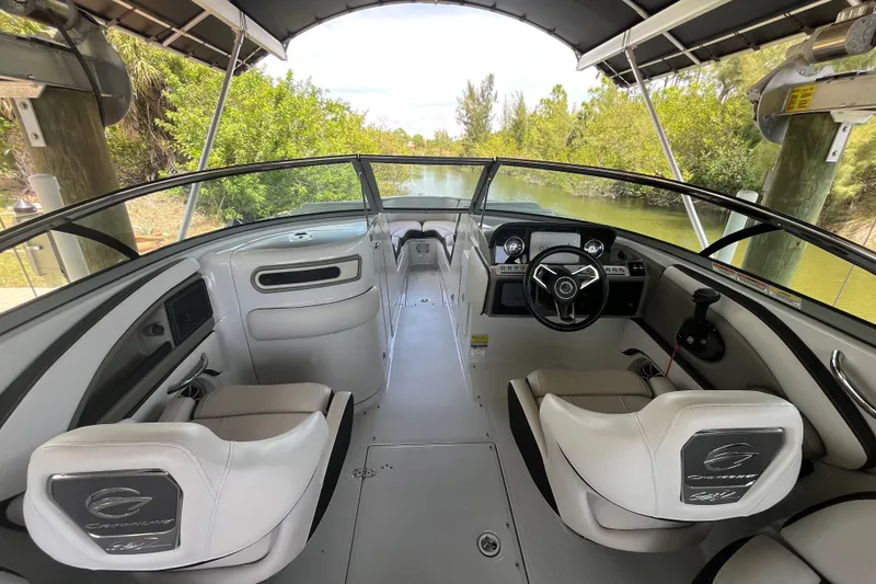 Slide: The Image of 2022 Crownline 260 XSS boat interior with steering wheel and seating. - 6