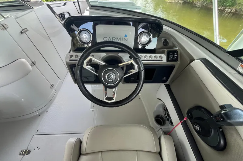 Slide: The Image of 2022 Crownline 260 XSS boat cockpit with Garmin navigation system and sleek steering wheel. - 9