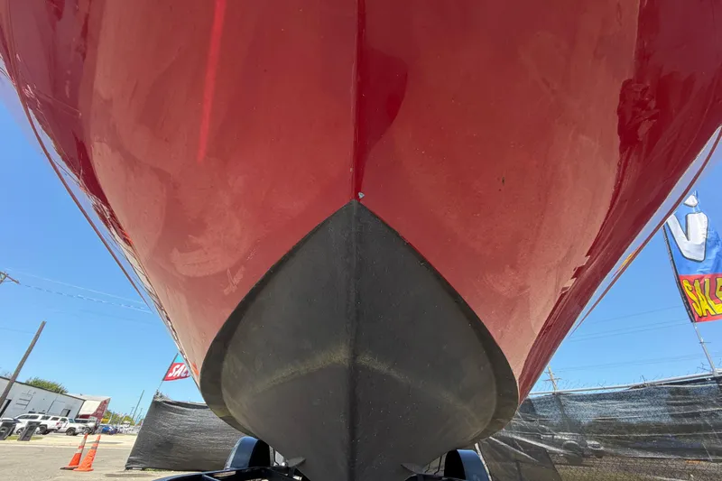 Slide: The Image of Red 2022 Hurricane SunDeck Sport 185 OB boat hull, viewed from below, outdoors. - 10