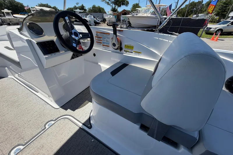 Slide: The Image of 2022 Hurricane SunDeck Sport 185 OB boat interior with steering wheel and seating. - 17