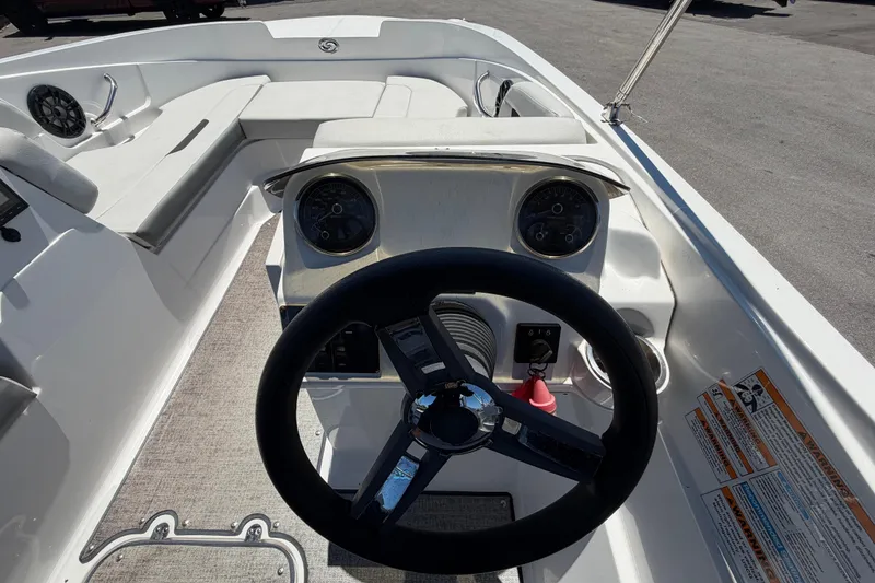Slide: The Image of Steering console of 2022 Hurricane SunDeck Sport 185 OB boat with gauges and seating. - 18