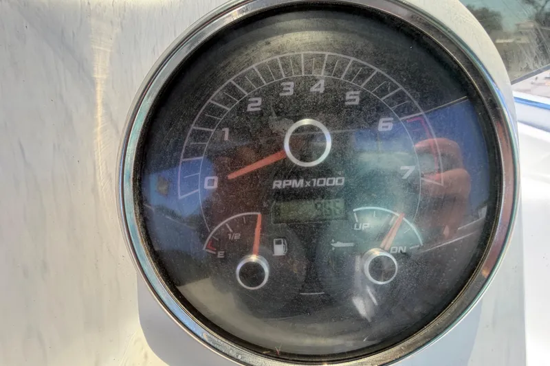 Slide: The Image of Close-up of a 2022 Hurricane SunDeck Sport 185 OB tachometer displaying RPM and fuel gauge. - 20