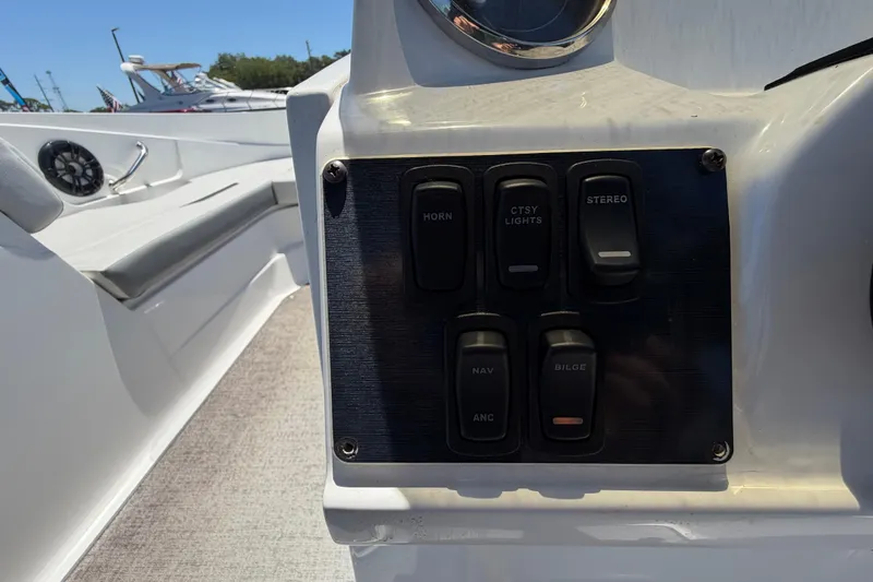 Slide: The Image of Control panel of 2022 Hurricane SunDeck Sport 185 OB boat with switches for horn, lights, and stereo. - 21