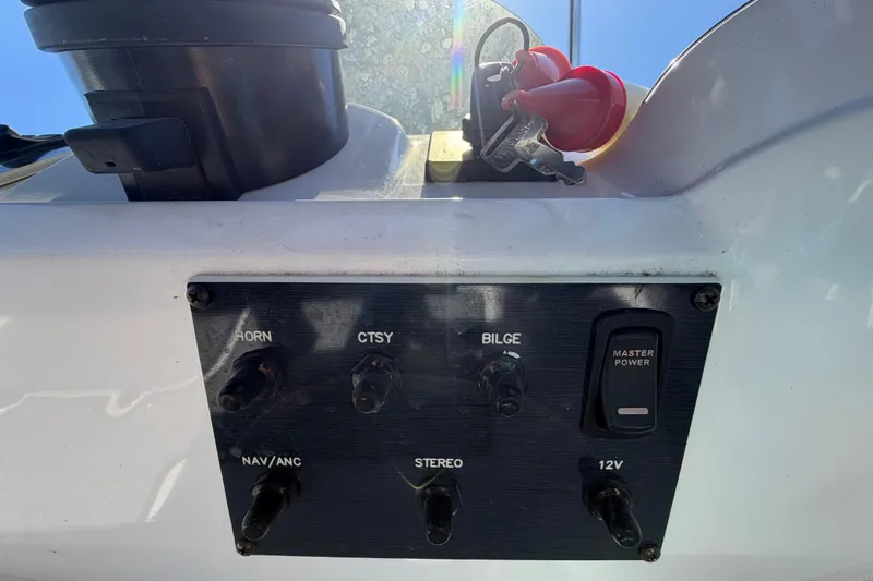 Slide: The Image of Control panel of 2022 Hurricane SunDeck Sport 185 OB boat with switches and keys. - 22