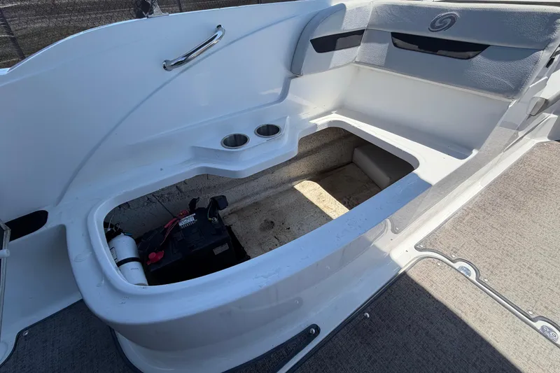 Slide: The Image of 2022 Hurricane SunDeck Sport 185 OB boat interior storage compartment with battery and cup holders. - 25