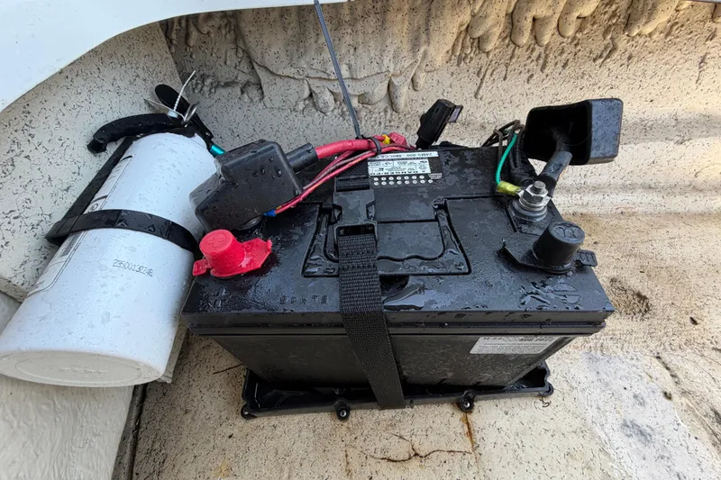 Slide: The Image of Battery setup in a 2022 Hurricane SunDeck Sport 185 OB boat, featuring secure wiring and components. - 26