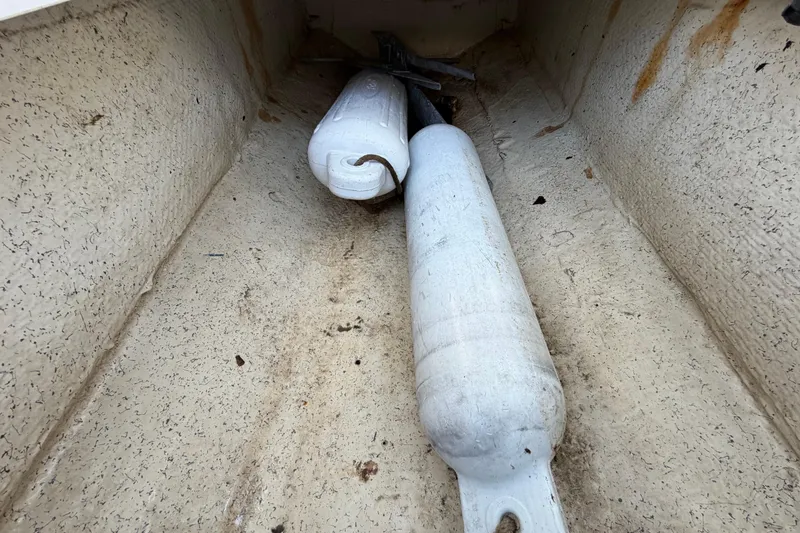Slide: The Image of Storage compartment of 2022 Hurricane SunDeck Sport 185 OB with boat fenders inside. - 29