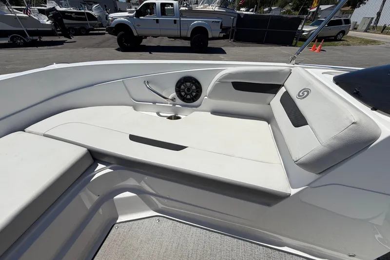 Slide: The Image of 2022 Hurricane SunDeck Sport 185 OB boat interior with white seating and speaker. - 40