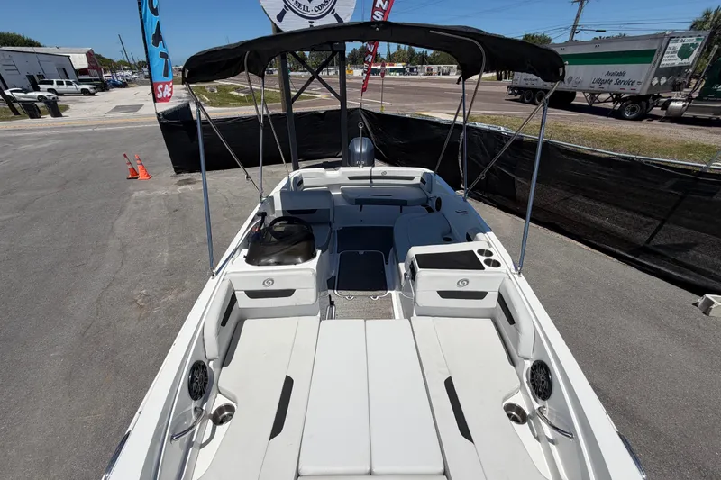 Slide: The Image of 2022 Hurricane SunDeck Sport 185 OB boat with canopy, parked outdoors on display. - 42