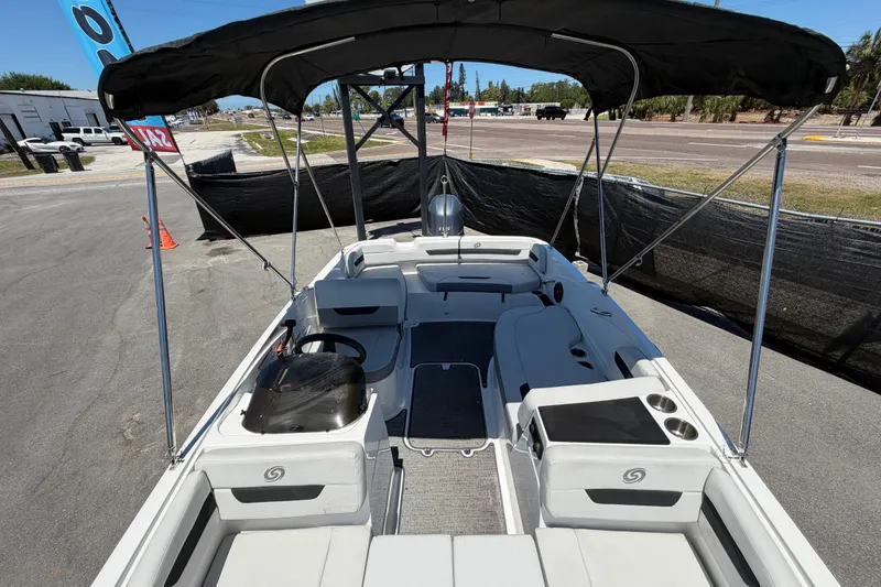 Slide: The Image of 2022 Hurricane SunDeck Sport 185 OB boat with canopy, parked on pavement. - 43