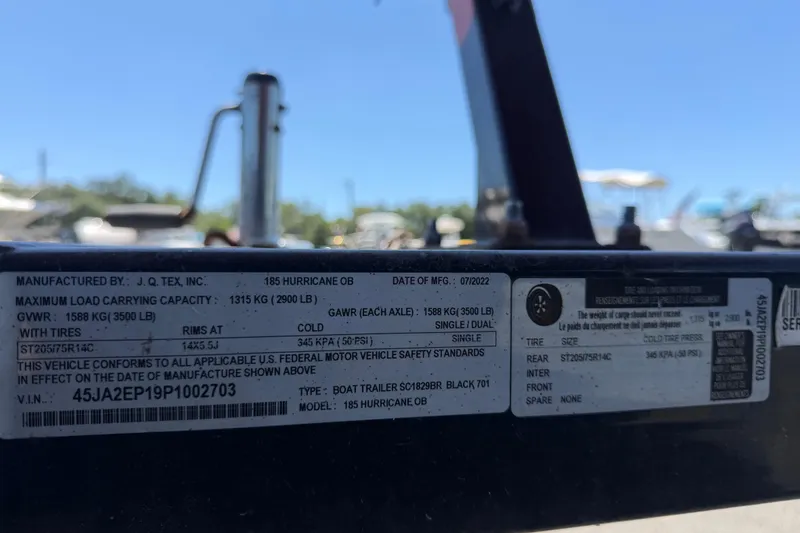 Slide: The Image of Label on a 2022 Hurricane SunDeck Sport 185 OB boat trailer, detailing specifications and compliance. - 60