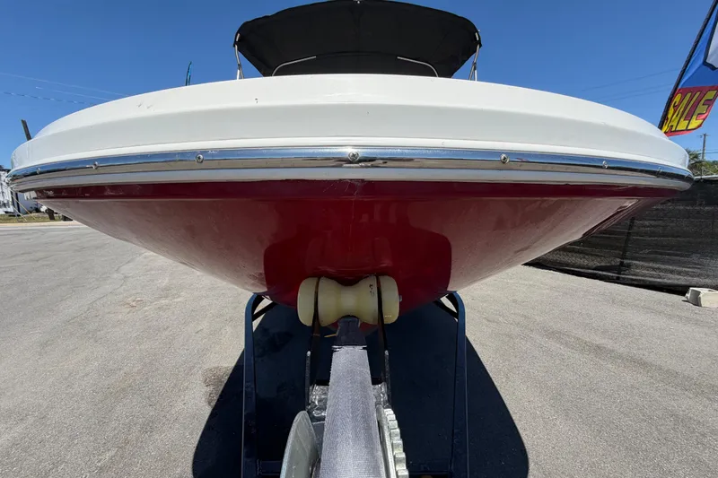 Slide: The Image of 2022 Hurricane SunDeck Sport 185 OB boat on trailer, red hull, sunny day. - 9